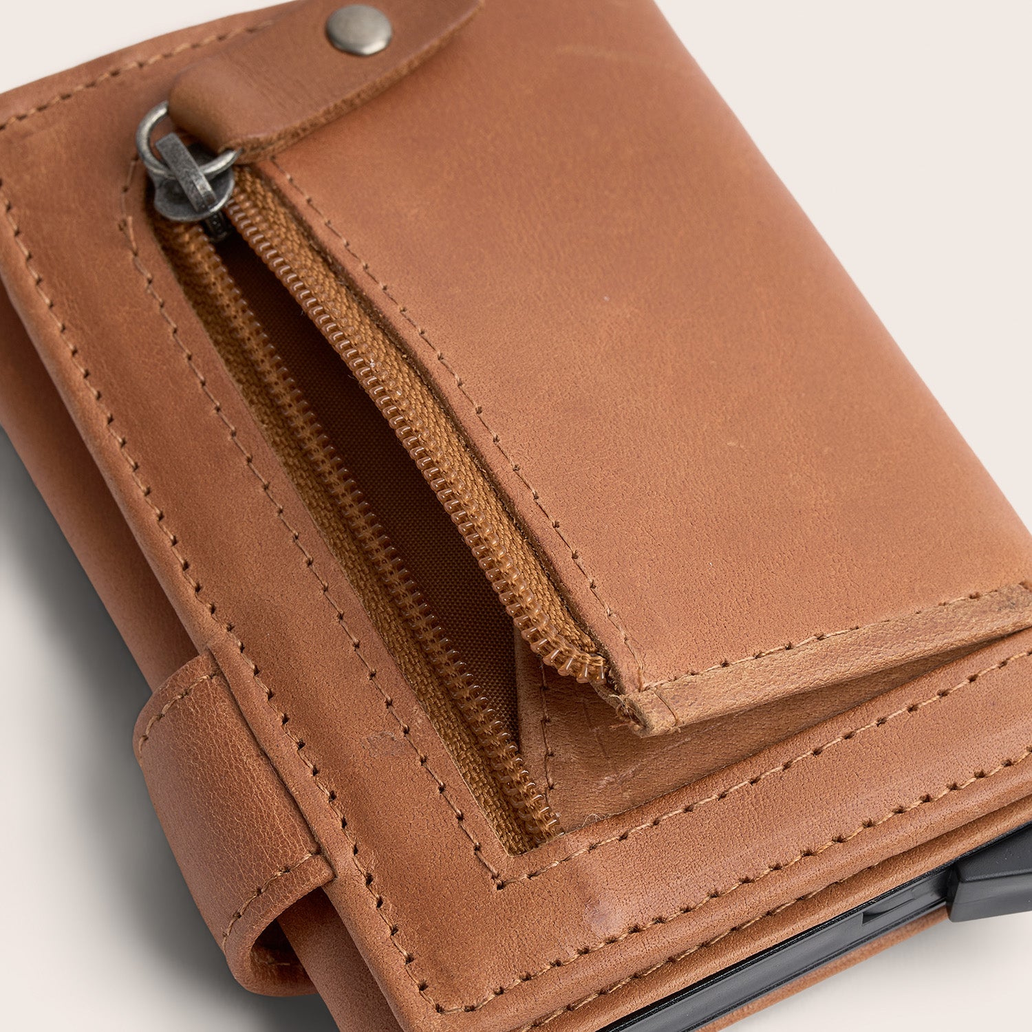 Porte-cartes en Cuir Cognac Leicester, gros plan sur une poche zippée ouverte