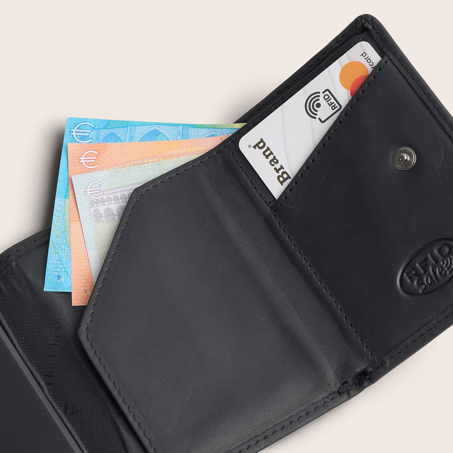 Leather Card Holder Black Palma, inside view, opened, with a card and banknotes, embossed 'RFID Safe'