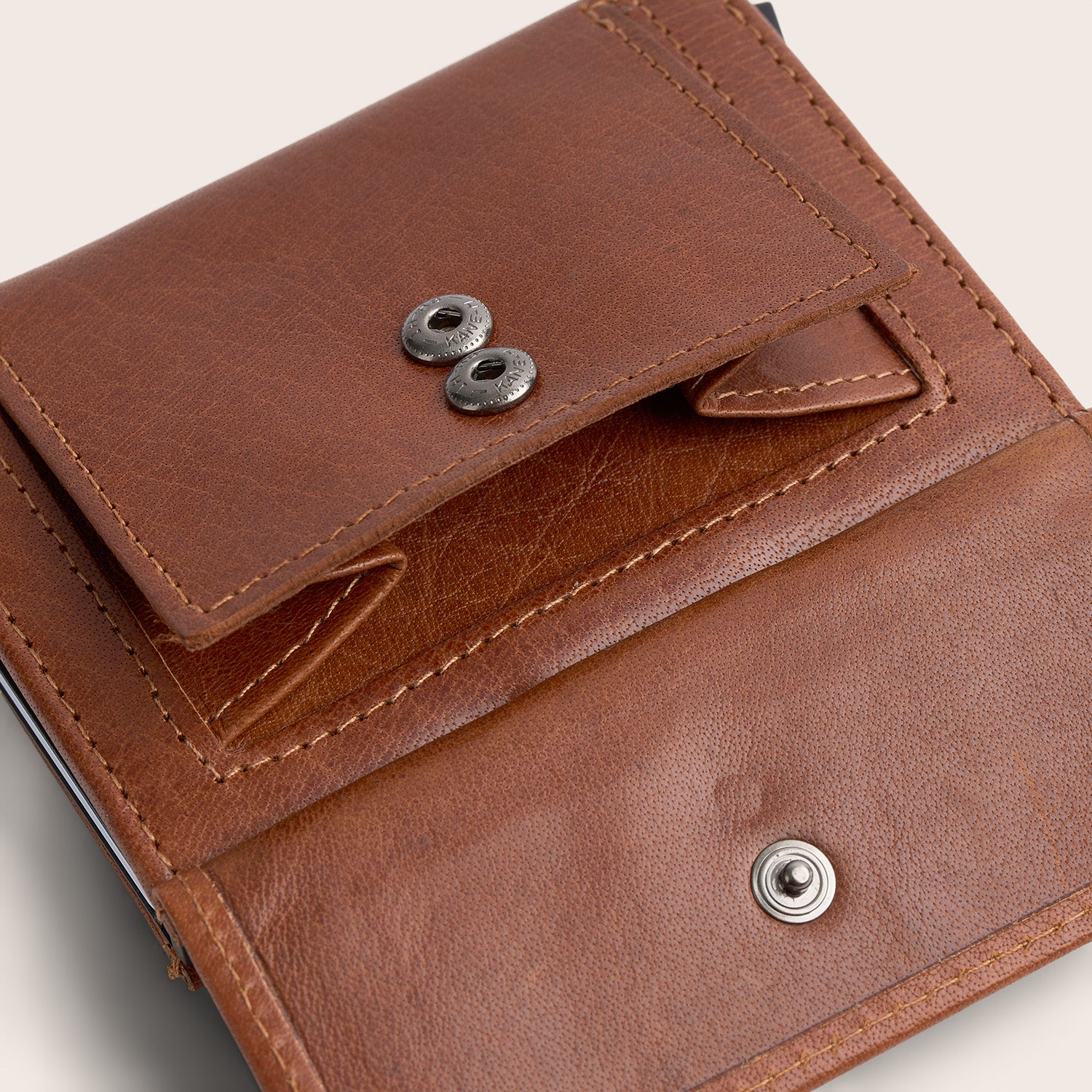 Leather Card Holder Cognac Hannover, close-up of the open coin pocket with snap button