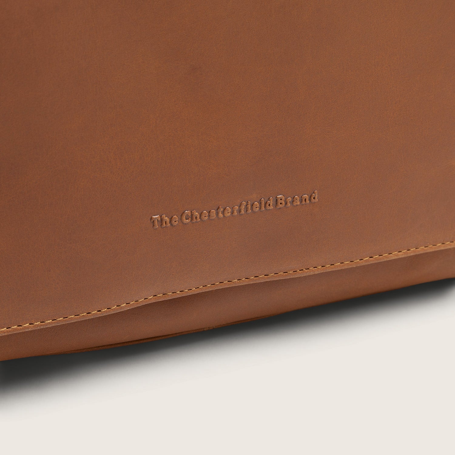 Leder Kulturtasche Cognac Rosario, Nahaufnahme des geprägten Logos