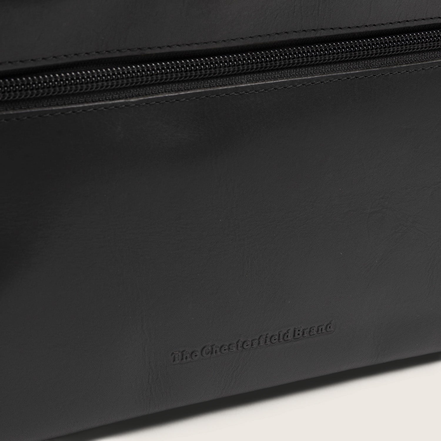 Leather Toiletry Bag Black Trevia, close-up of the embossed logo
