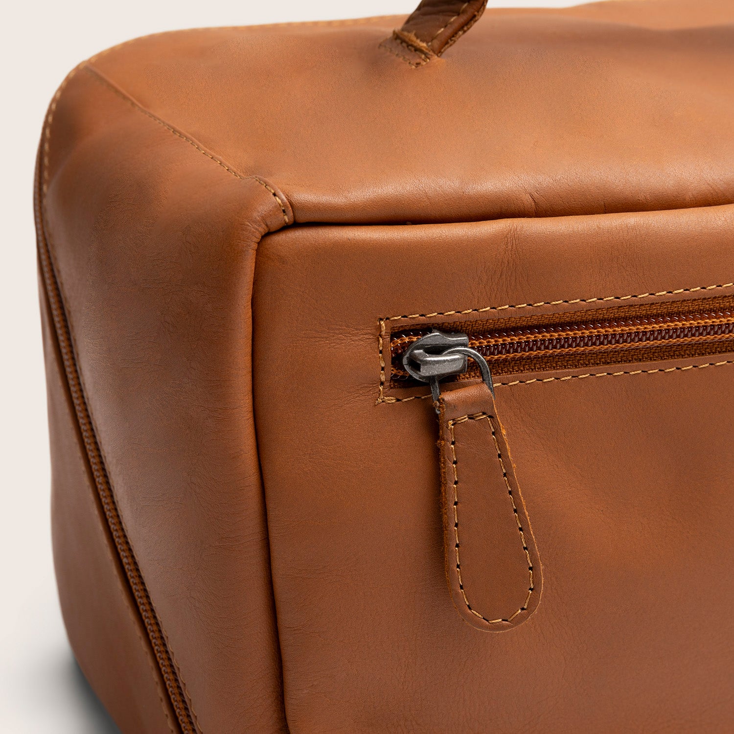 Trousse de Toilette en Cuir Cognac Trevia, gros plan sur une poche zippée