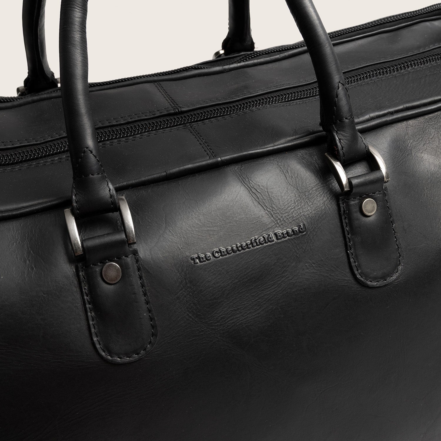 Leather Weekender Trolley Black Jayven, close-up of the embossed logo 'The Chesterfield Brand'