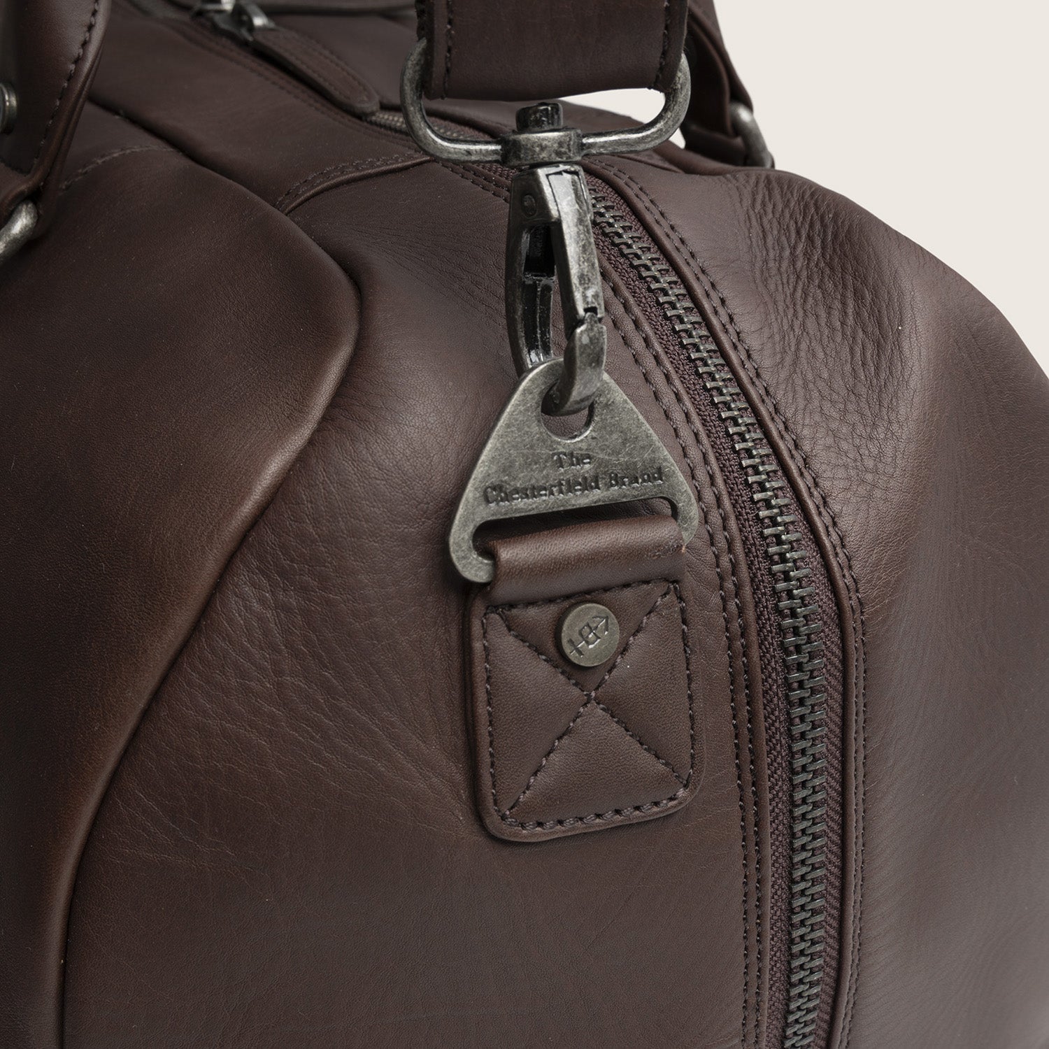 Leather Weekender Bag Brown Perth, close-up of the snap hook with 'The Chesterfield Brand'