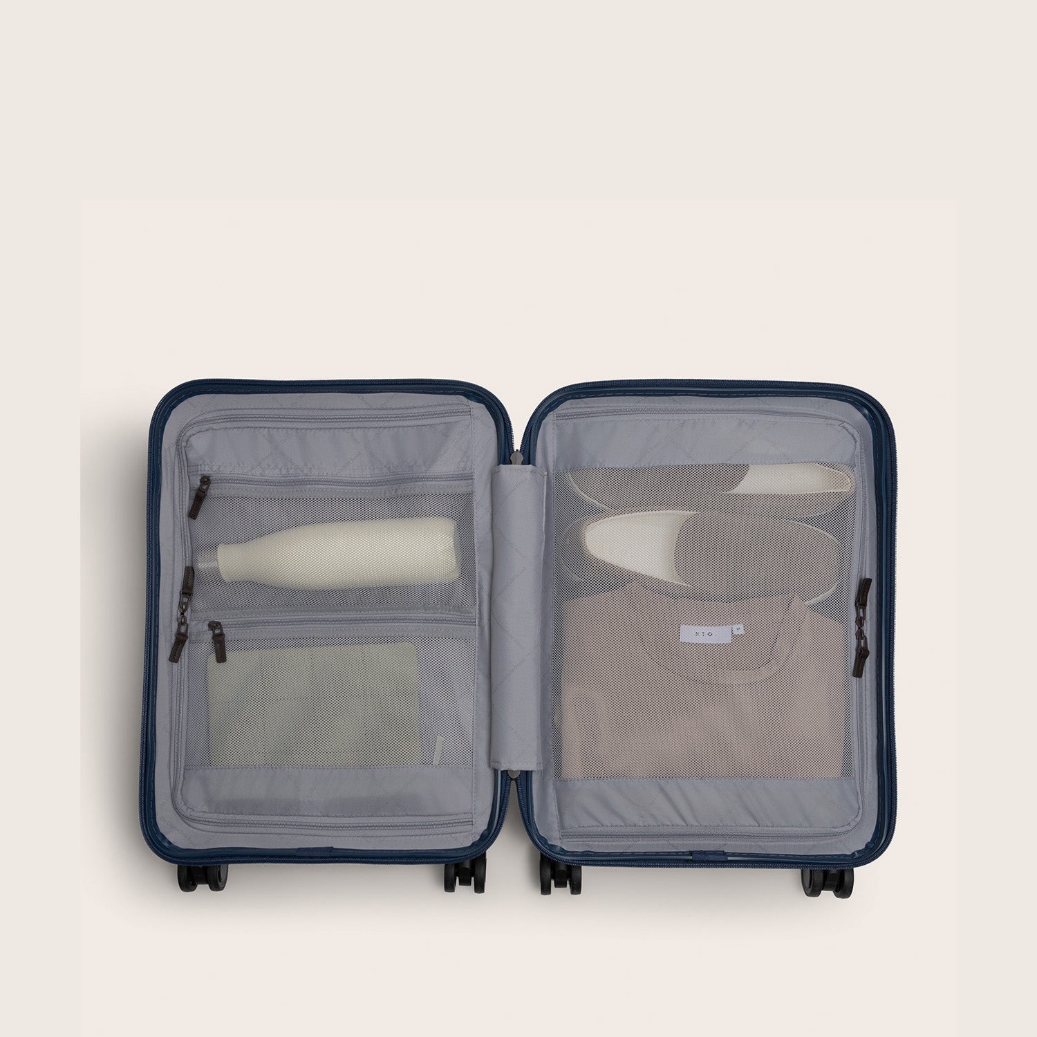 Hand Luggage Suitcase Nordic Navy Zuna, inside view, opened, with travel items
