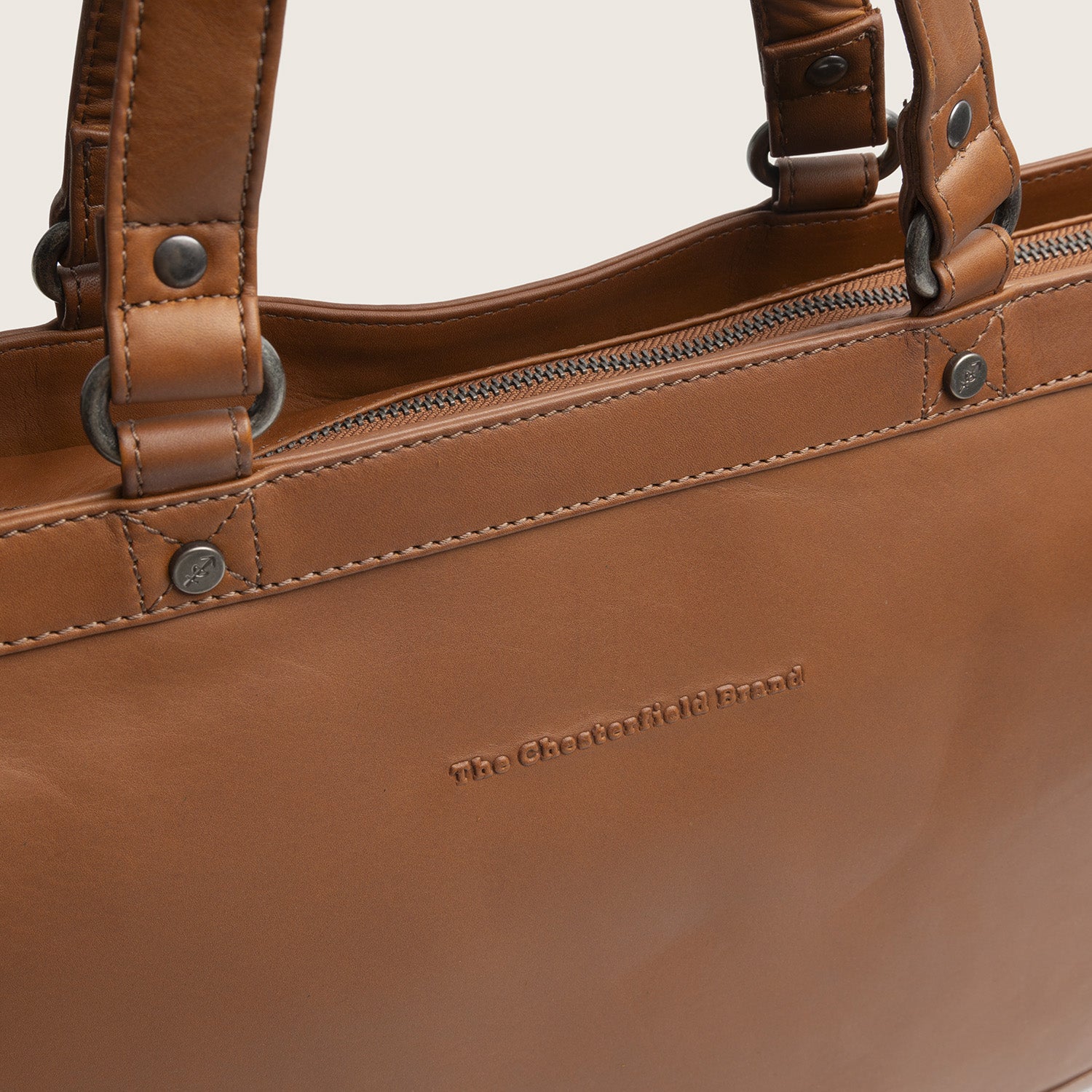Leder Shopper Cognac Manly, Nahaufnahme des geprägten Logos