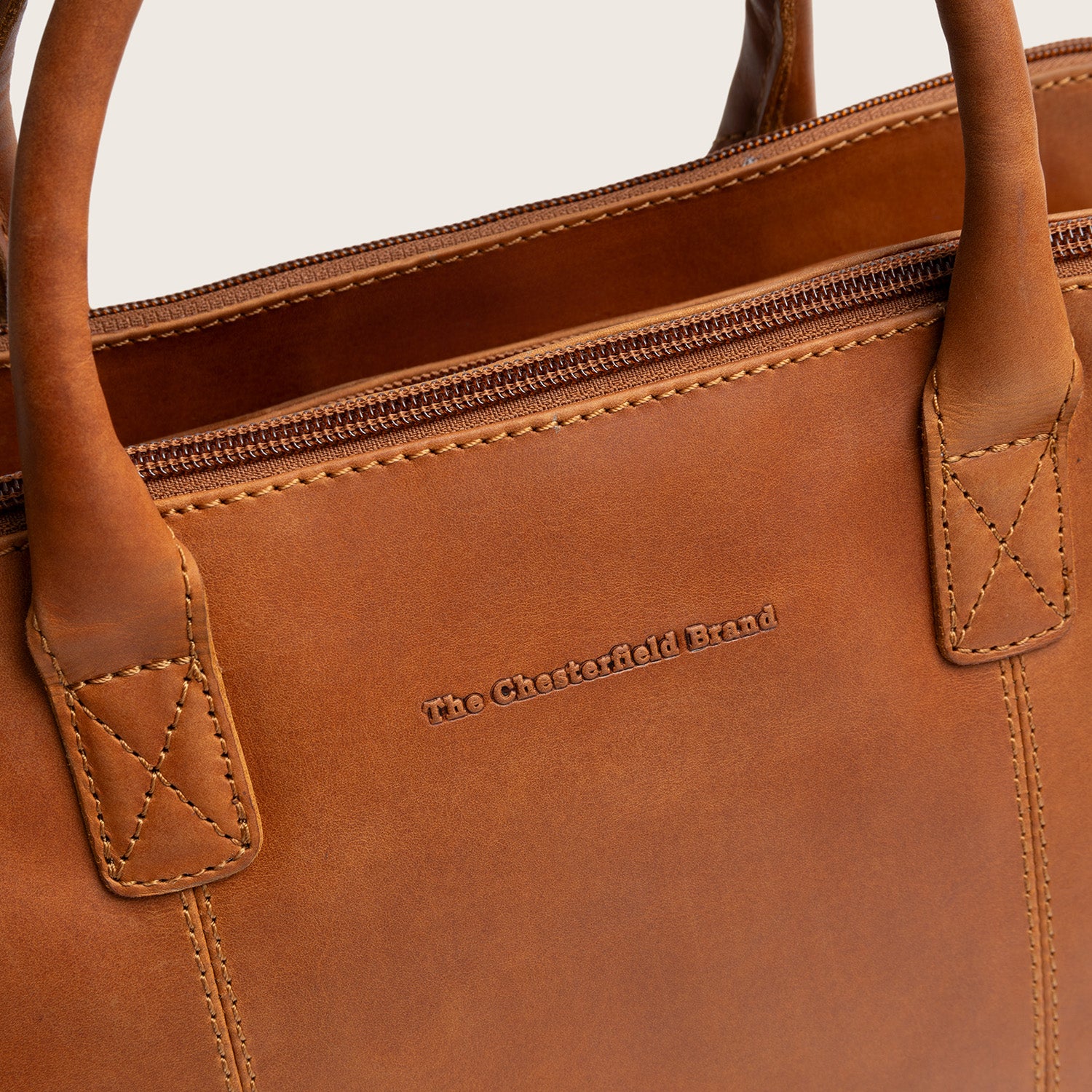 Leather Handbag Cognac Layton, close-up of the embossed logo