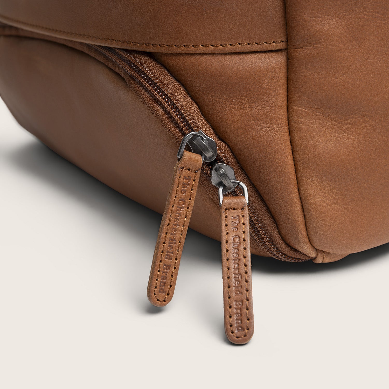 Leather Laptop Backpack Cognac Rich, close-up of a zip pocket