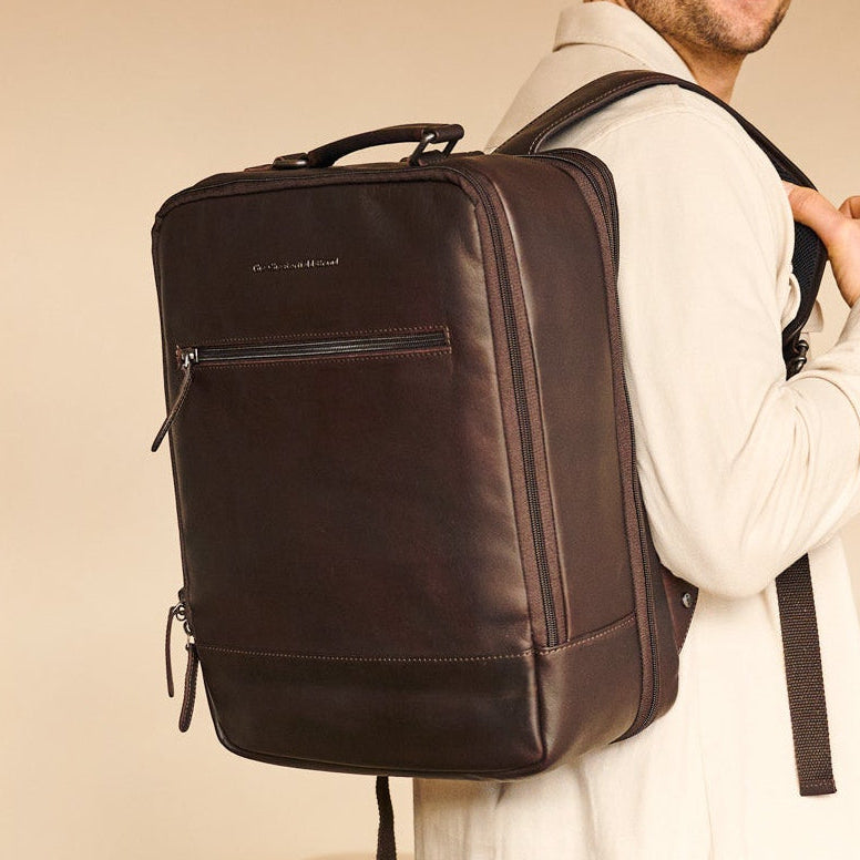 Man wearing a brown backpack indoors