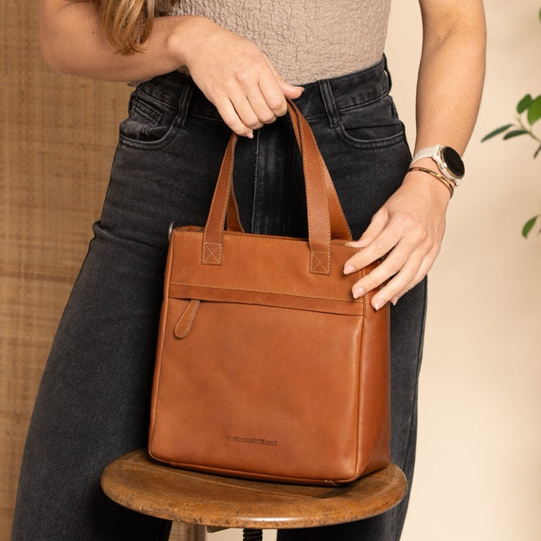 Cognac leather handbag in a studio setting